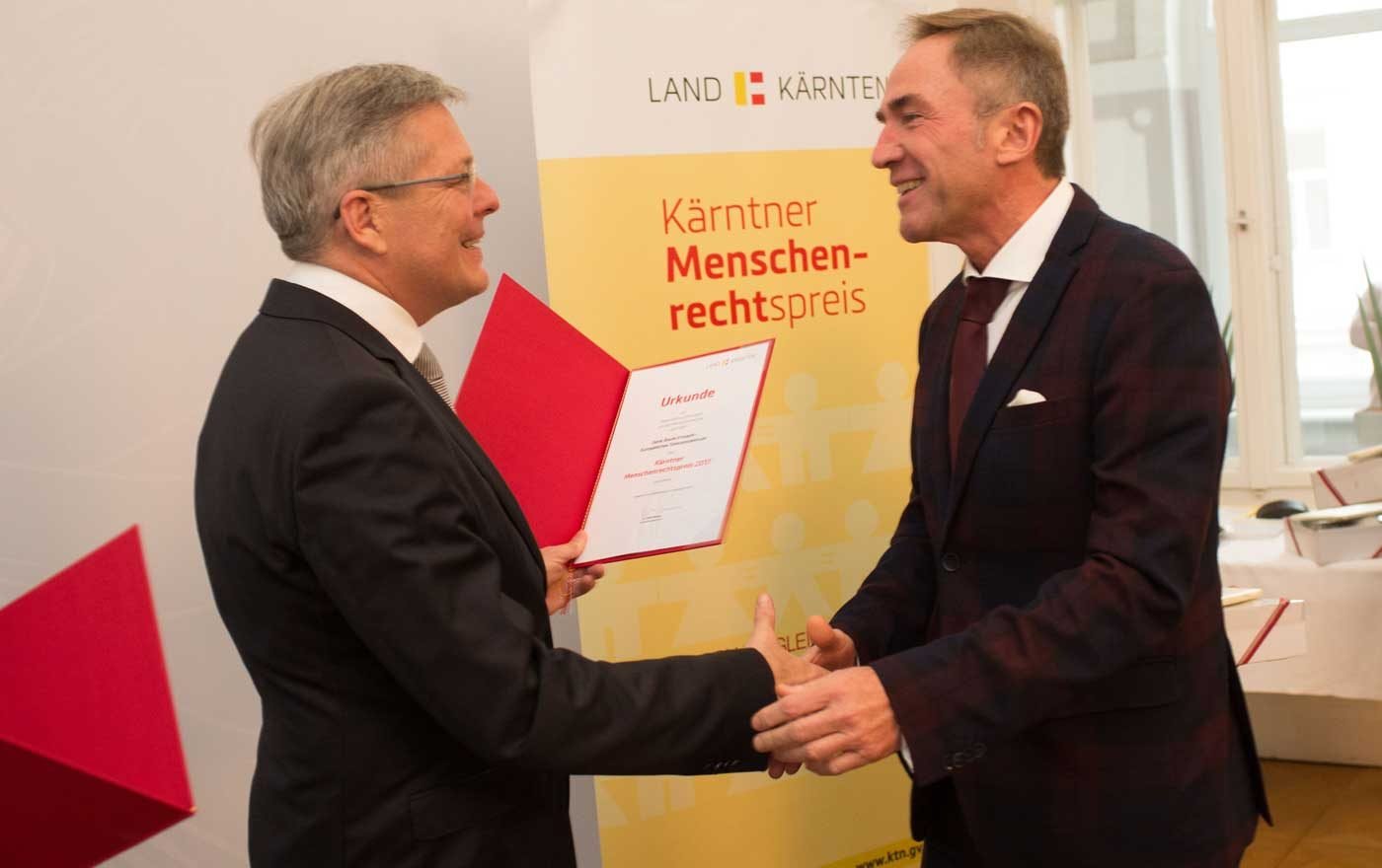 Landeshauptmann Peter Kaiser überreicht Superintendent Manfred Sauer den Menschenrechtspreis. Foto: LPD/Peter Just